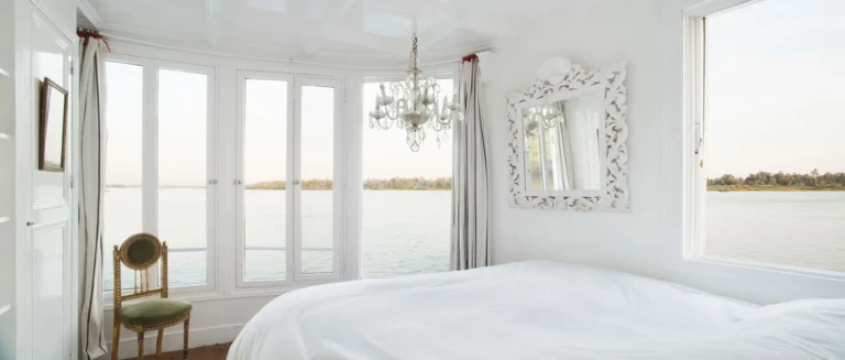Nour El Nil cabin bed with ornate mirror and river view