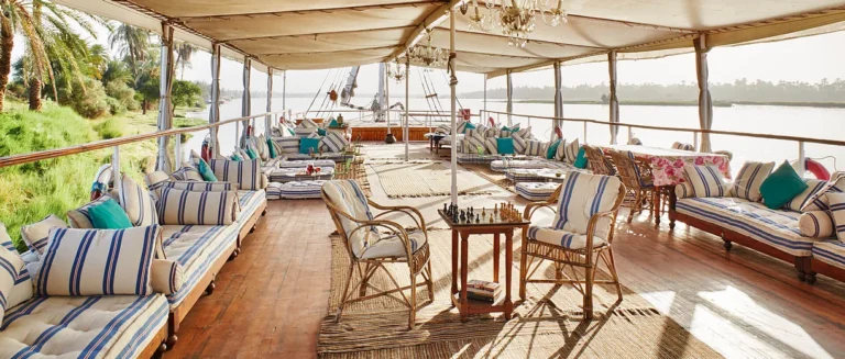 Shaded deck with striped cushioned sofas on the Nour El Nil