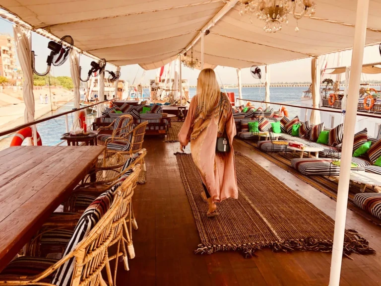 Woman walking along the covered deck of the Nour El Nil