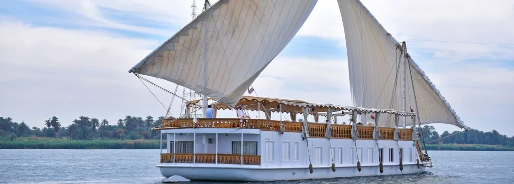 Nour El Nil dahabiya under sail on the Nile