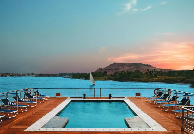 Oberoi Zahra pool at sunset with a felucca on the Nile
