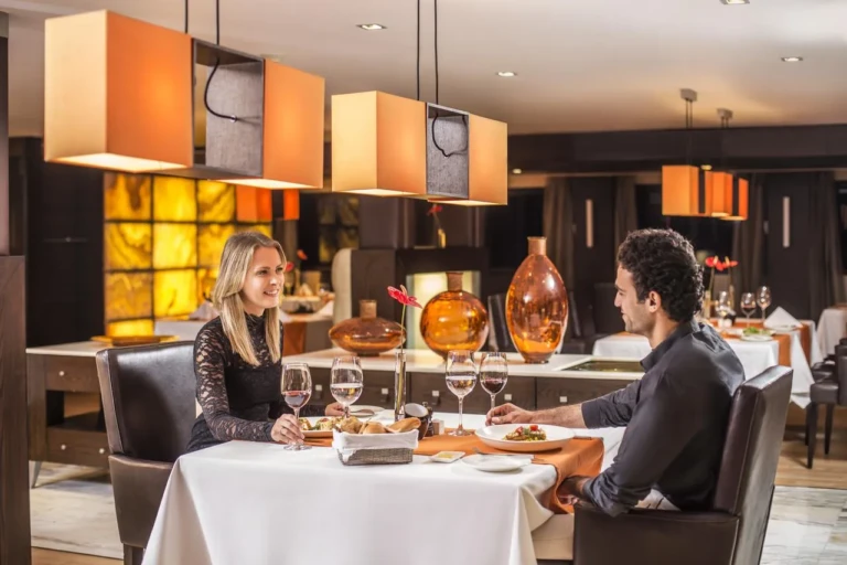 Couple dining at a set table in the Oberoi Zahra restaurant