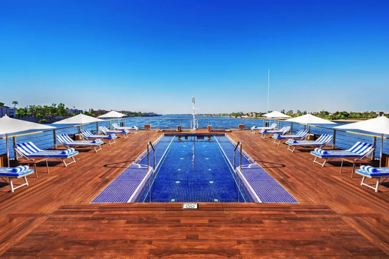 Oberoi Zahra pool deck with sun loungers and umbrellas
