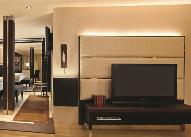 Suite TV wall with view into the bedroom on the Oberoi Zahra