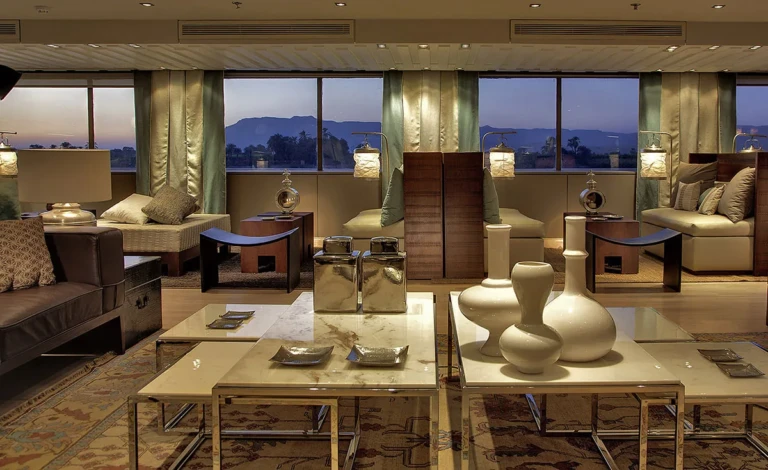 Lounge with sofas and white vases at dusk