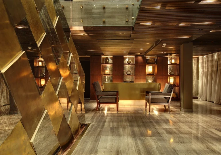 Lobby with bronze-panelled wall and armchairs
