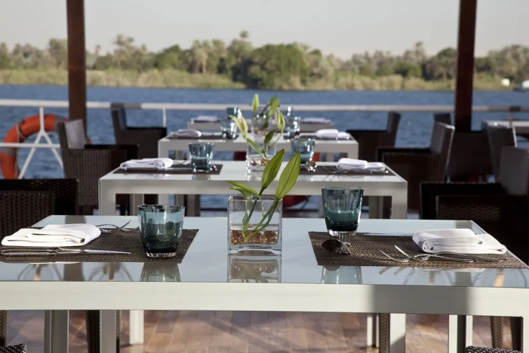 Deck dining tables with flowers overlooking the Nile
