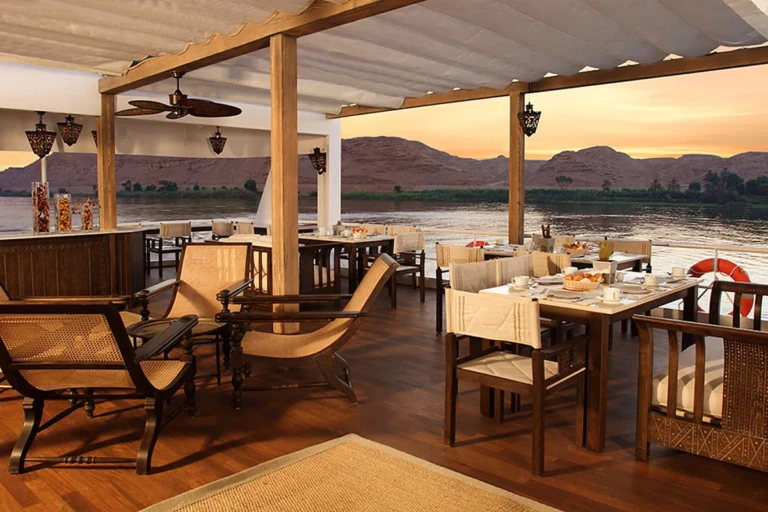 Shaded open-air deck dining area overlooking the Nile on Sun Boat III
