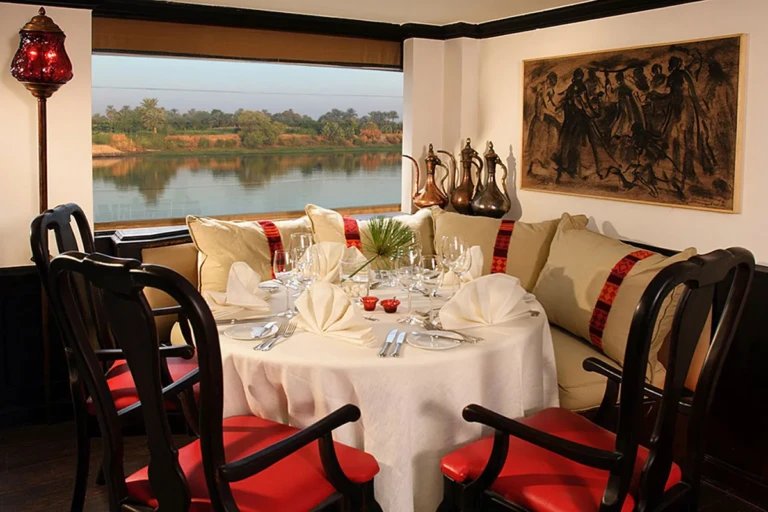 Dining table set by a Nile window on Sun Boat III