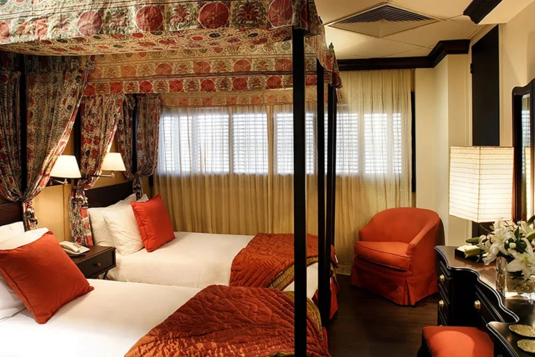 Canopy twin beds with red bedspreads on Sun Boat III