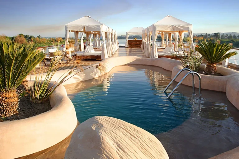 Sun Boat III rooftop pool with white cabanas and palm plants