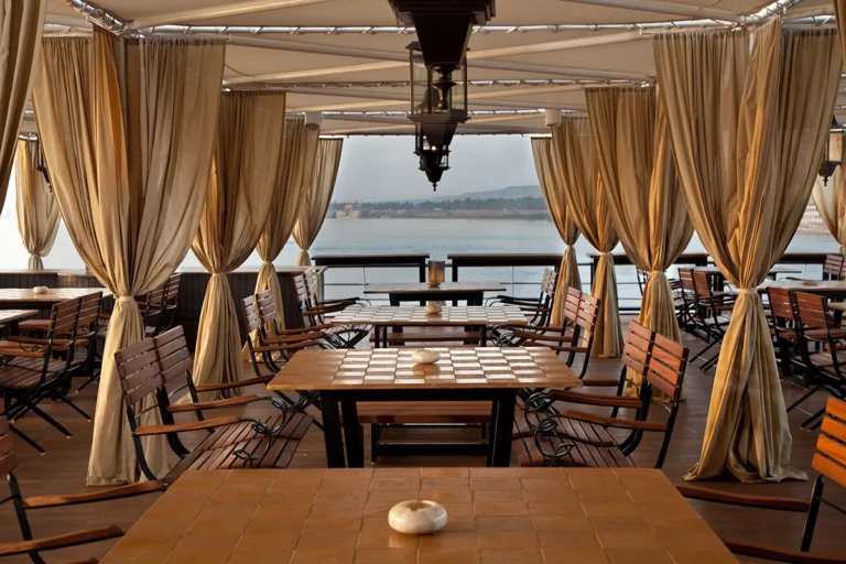 Curtained deck tables with checkerboards on the Sun Boat IV