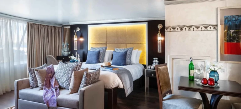 Sun Boat IV suite with sofa, lit headboard and dining table