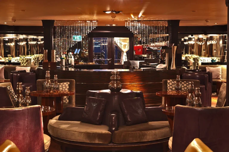 Sun Boat IV bar with circular banquette and backlit shelves