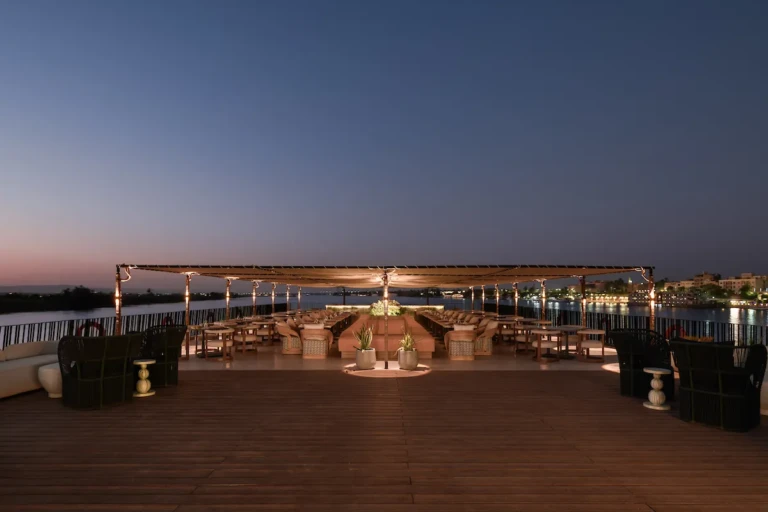 Soleil sun deck seating under a canopy at night