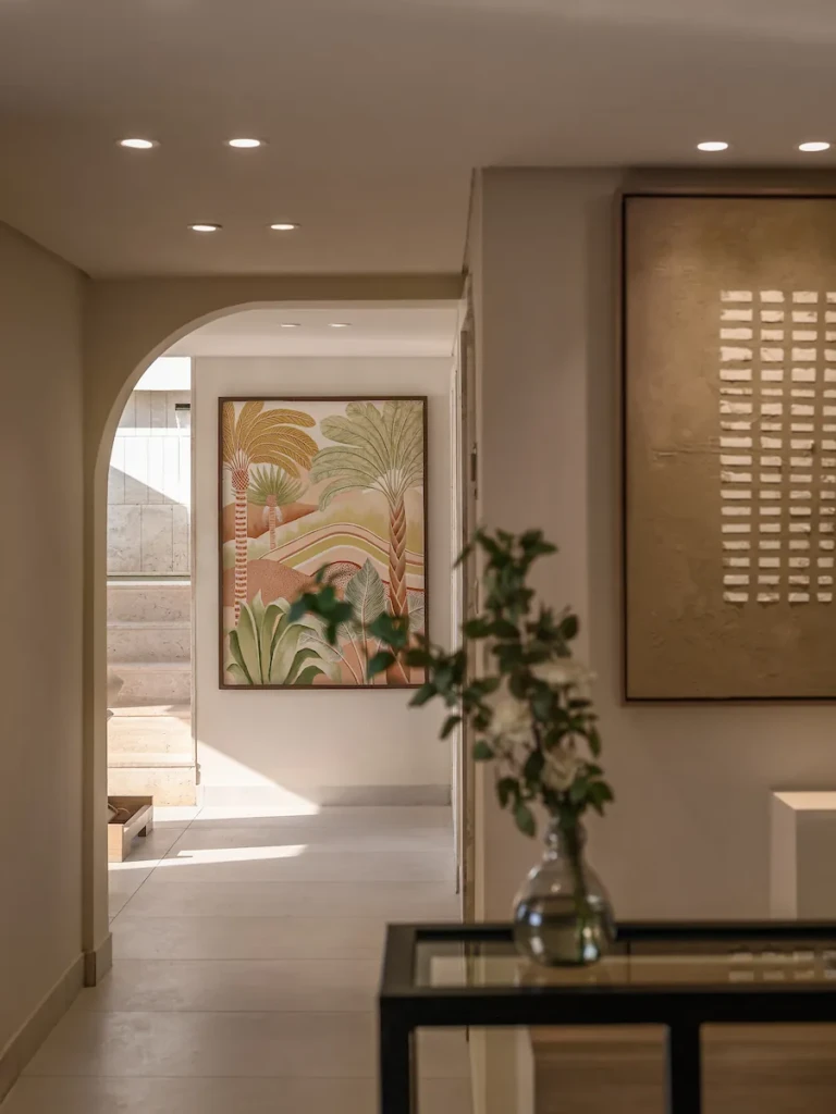 Arched hallway with botanical painting and glass console on the Soleil