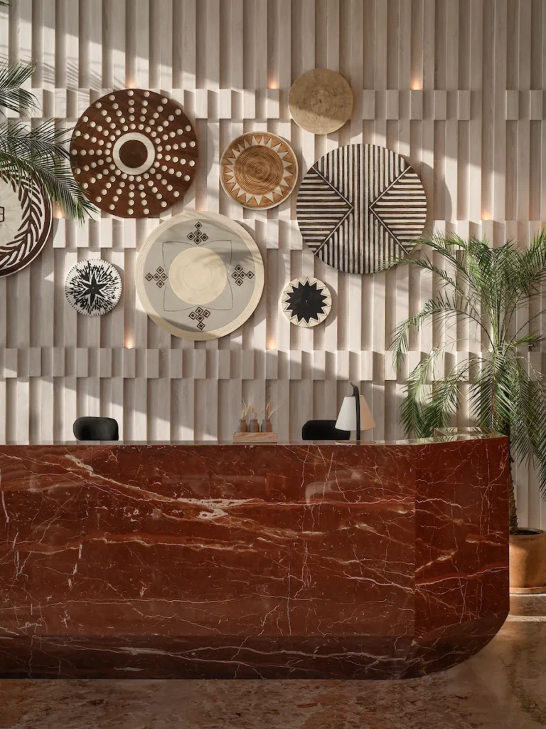 Red marble reception counter and decorative woven plates on the Soleil