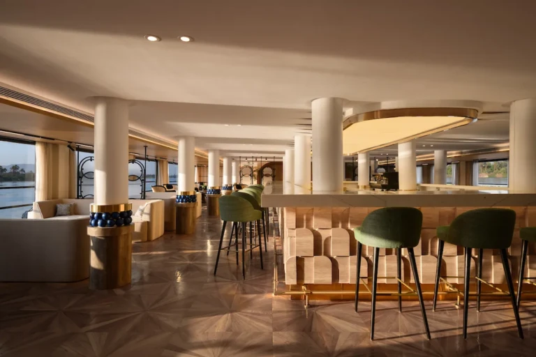 Soleil bar with green bar stools and white columns