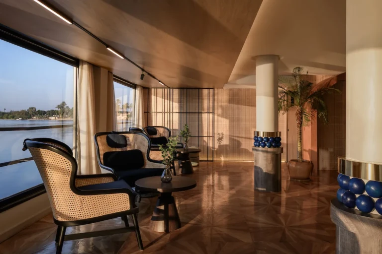 Soleil lounge armchairs by the windows with columns and parquet floor