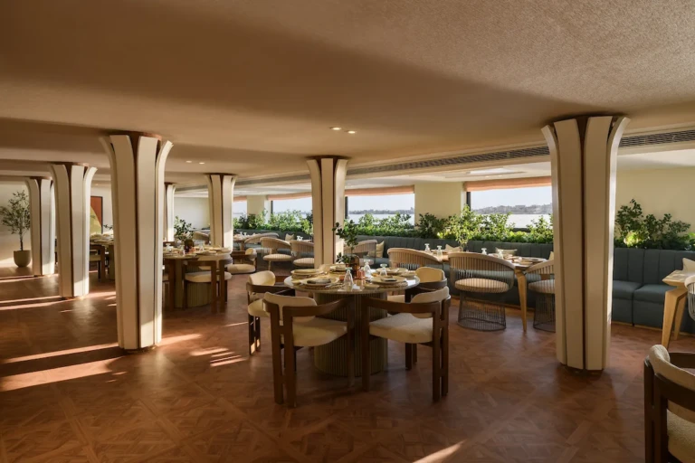 Soleil restaurant dining tables with sunlit windows and plants