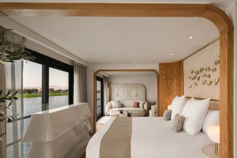Soleil suite king bed with wraparound Nile windows and lounge beyond