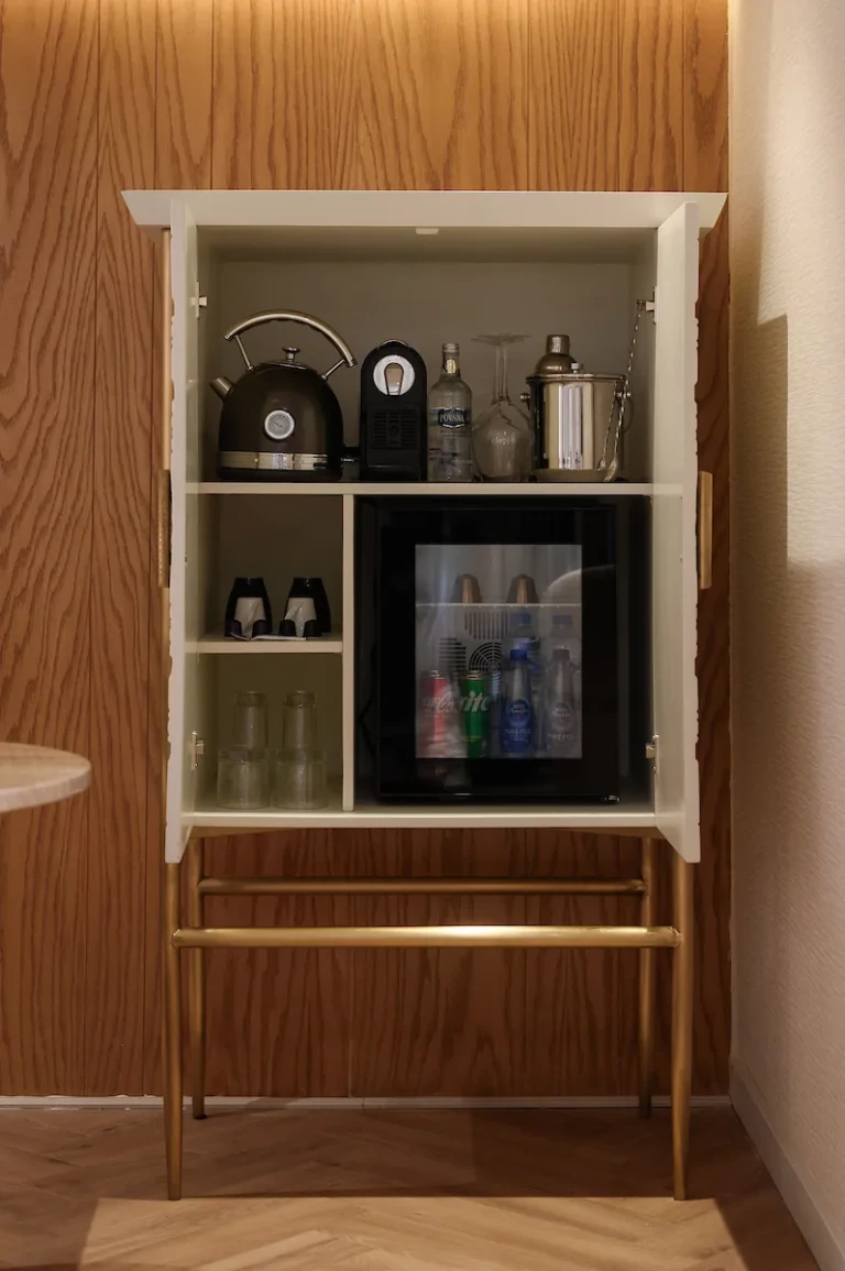 Minibar cabinet with kettle, coffee machine and fridge on the Soleil