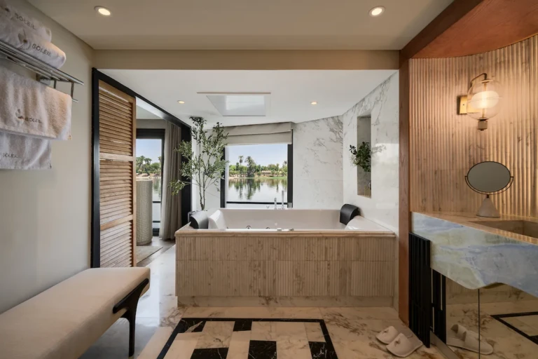 Soleil bathroom soaking tub beside a window overlooking the Nile