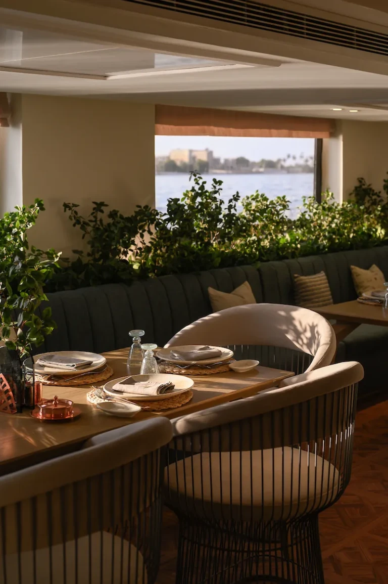 Soleil restaurant table set beside a Nile view window