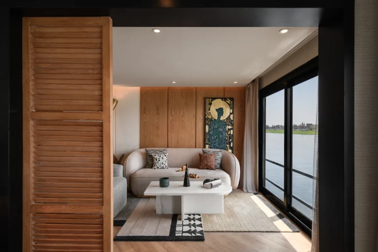 Soleil suite sitting area seen through a louvered wooden door