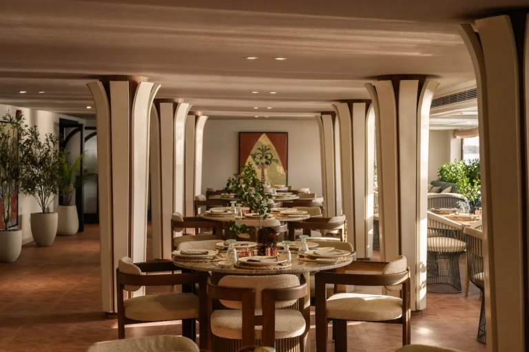 Soleil restaurant with set round tables between columns