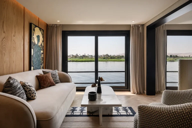 Soleil suite lounge with sofa and floor-to-ceiling Nile view windows