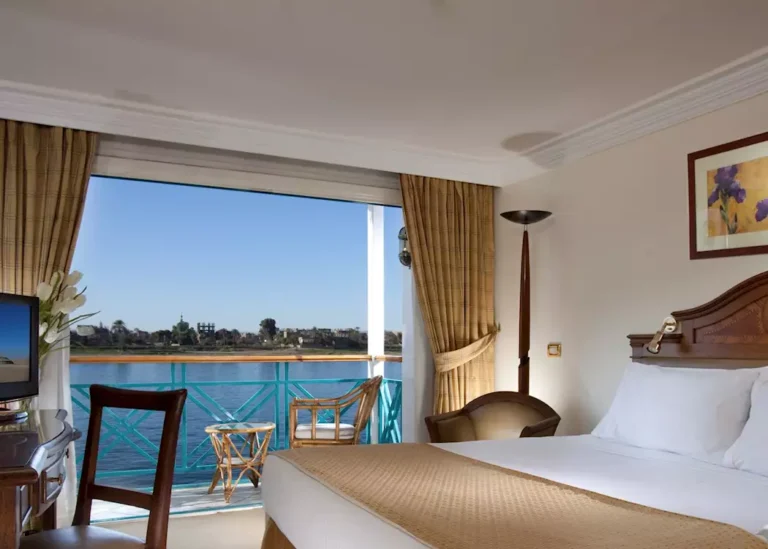 Cabin bed facing an open balcony with Nile view on the Sonesta Moon Goddess