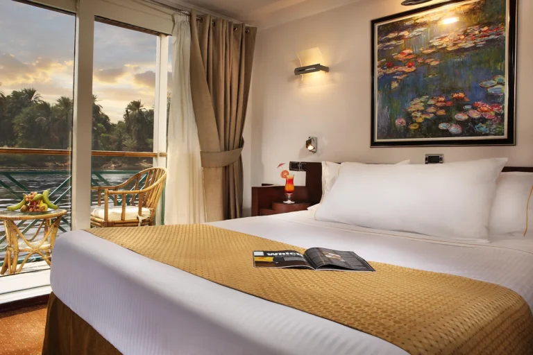 Double bed with balcony door at dusk on the Sonesta Moon Goddess