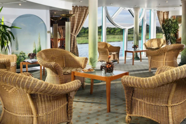 Wicker armchairs in an observation lounge on the Sonesta Moon Goddess