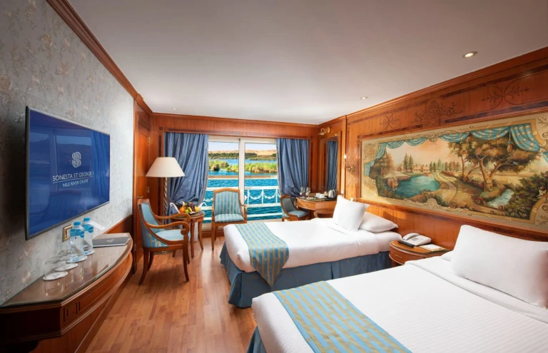 Twin cabin with wall TV and Nile balcony seen from bed corner