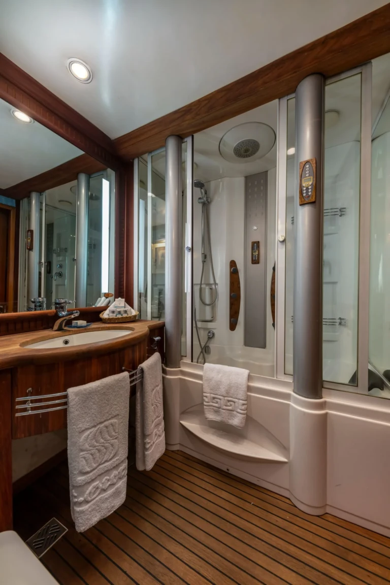 Bathroom sink and shower cabin with folded towels