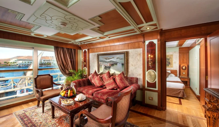 Suite living room with red sofa and Nile view window