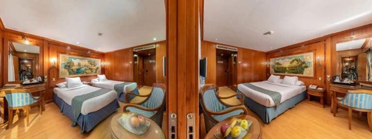 Split panoramic view of a twin bed cabin with armchairs