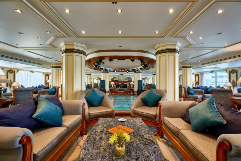 Lounge seating around a flower-topped table with bar beyond