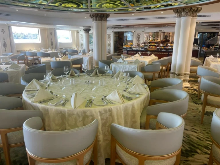 Round dining table set for eight with cushioned chairs