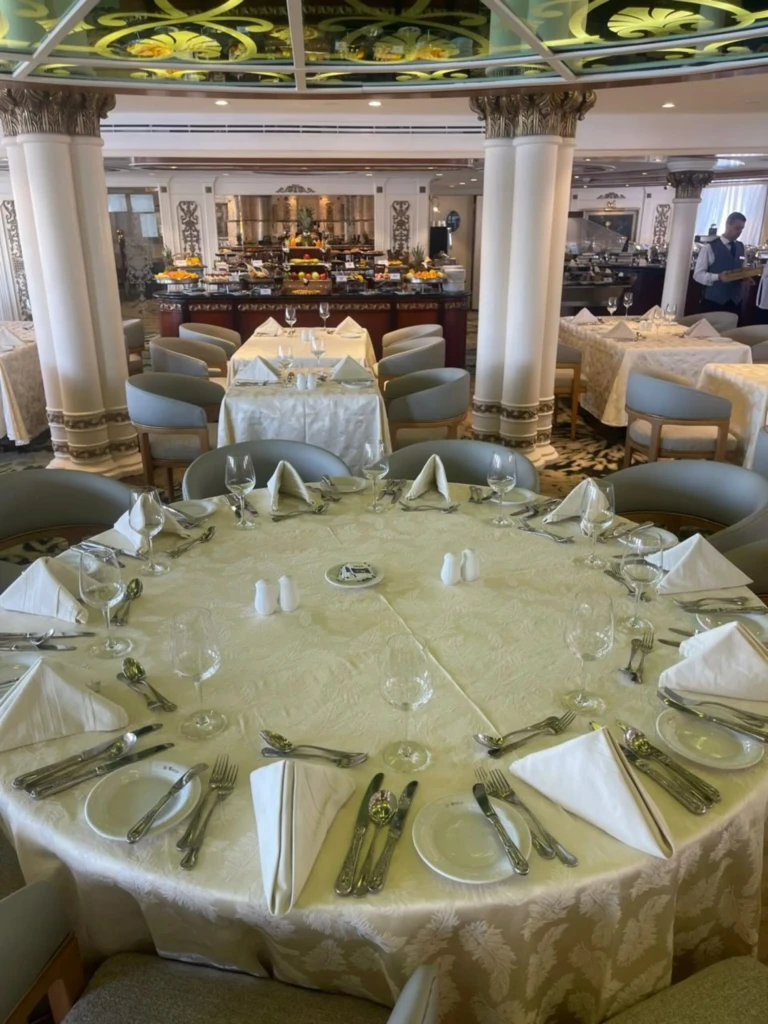 Round restaurant table set with glasses and folded napkins