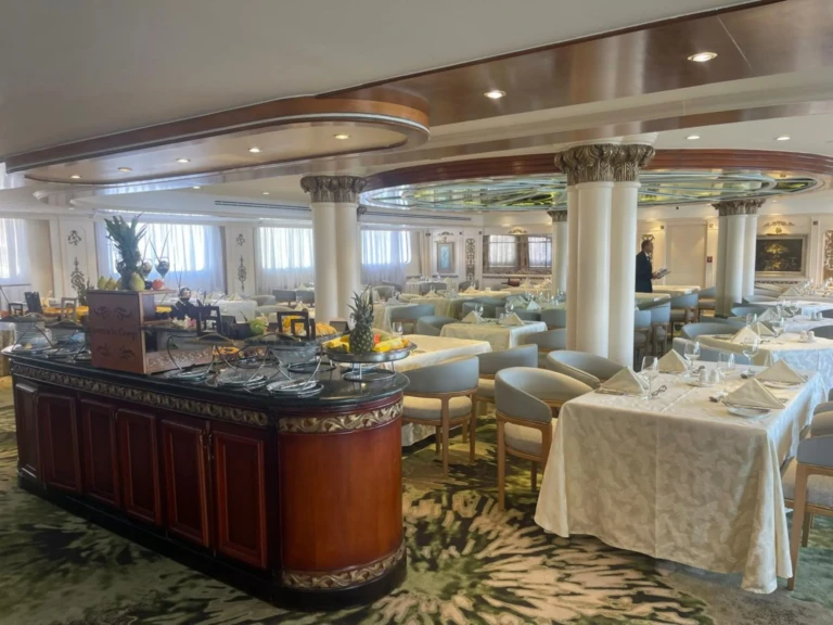 Restaurant buffet counter and dining tables beside windows