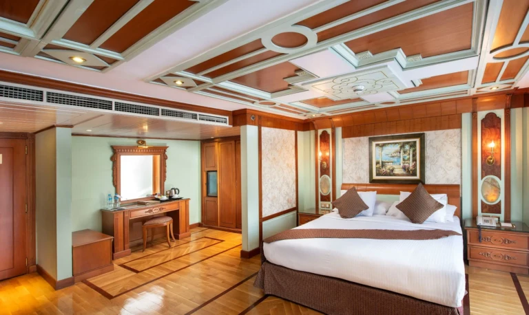 Double bed cabin with desk, wood-panel ceiling and parquet floor