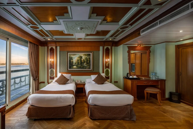 Twin bed cabin with Nile view window at dusk