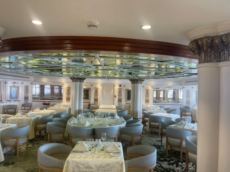 Main restaurant hall with columns and set dining tables