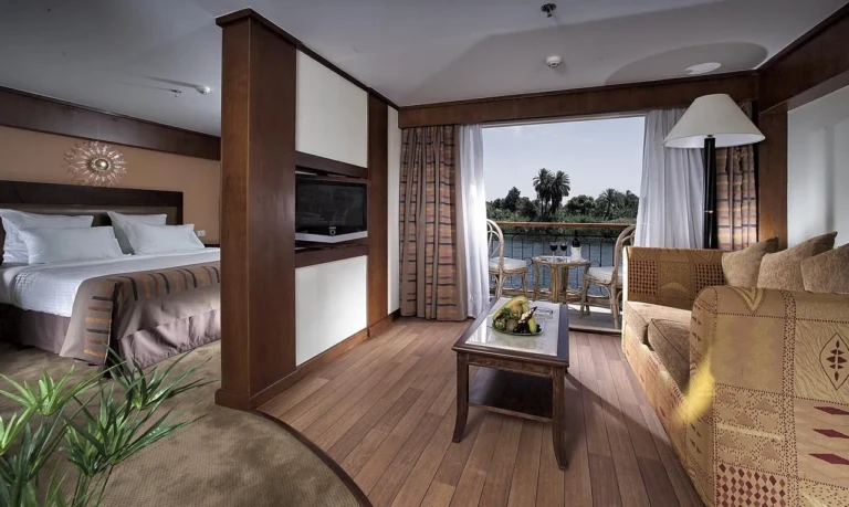 Sonesta Star Goddess suite with bed, sofa and balcony door