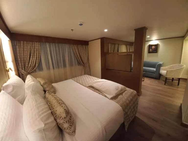 Sonesta Star Goddess suite bedroom with double bed and lounge corner