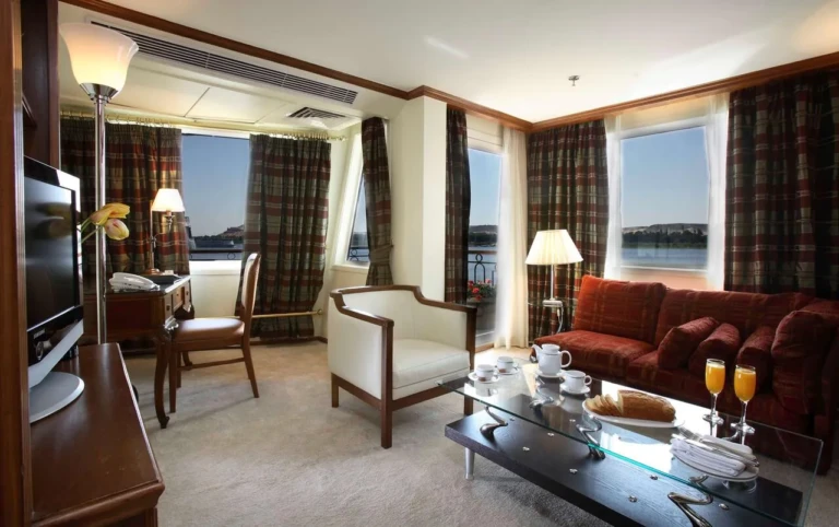 Sonesta Star Goddess suite living room with red sofa and Nile windows