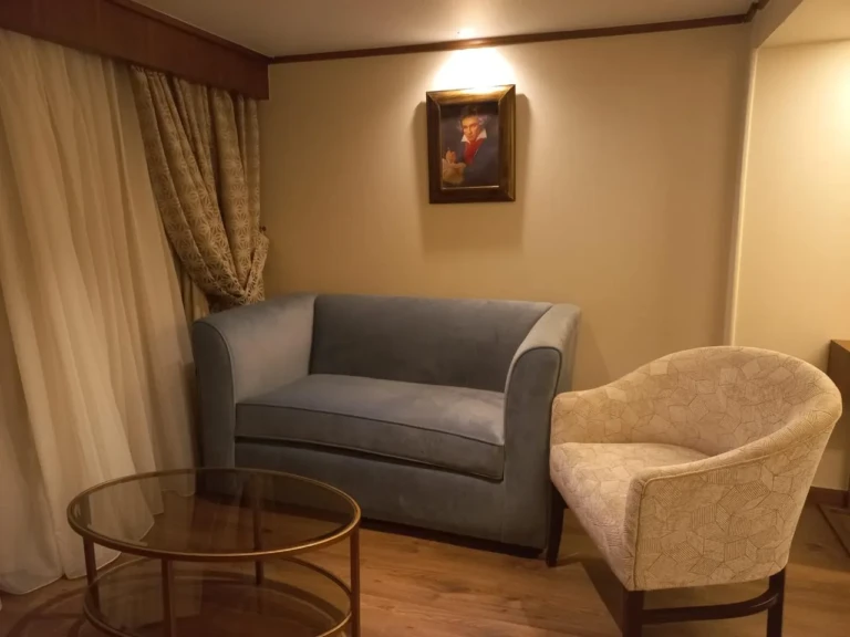 Grey loveseat, armchair and glass side table on the Sonesta Star Goddess