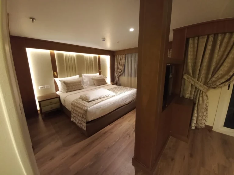 Double bed with backlit headboard in a Sonesta Star Goddess suite